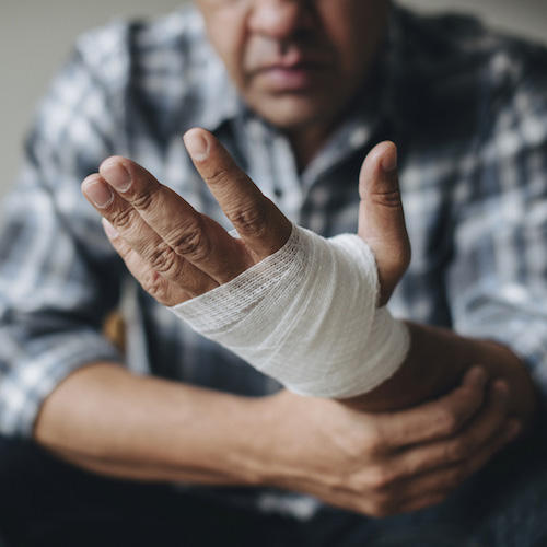 Man with a gauze bandage wrapped around his hand